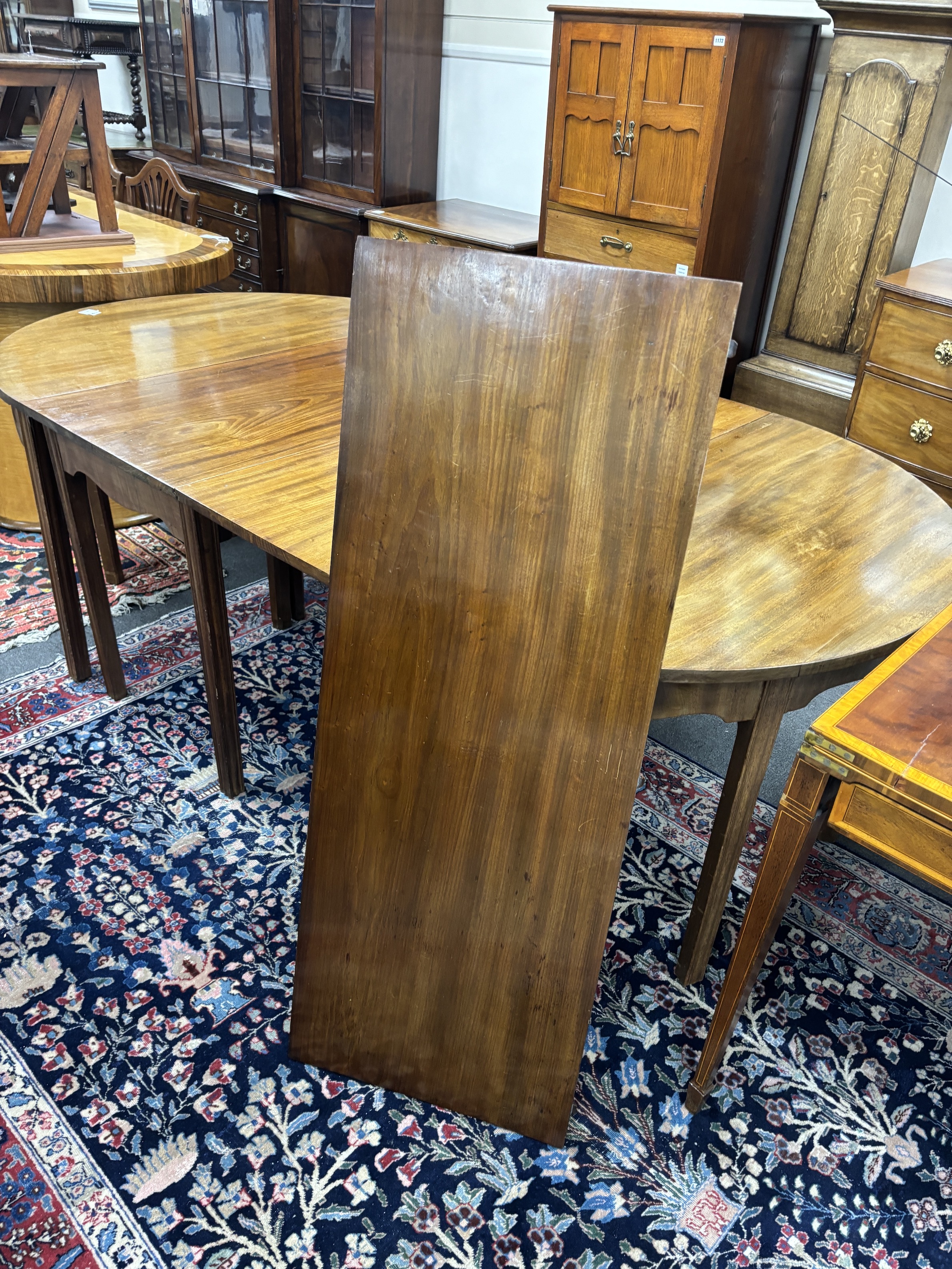 A George III mahogany D end extending dining table, 264cm extended, three spare leaves, width 121cm, height 72cm